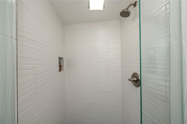 interior details featuring tiled shower