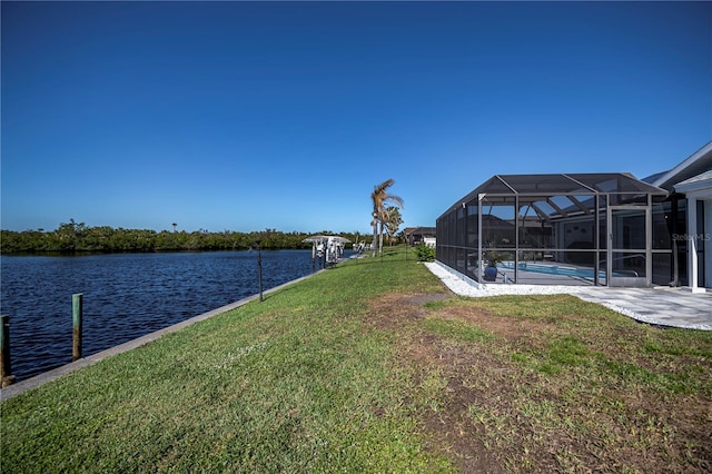 view of yard featuring a dock, a water view, a lanai, and an outdoor pool