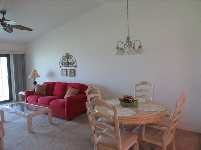 dining room with carpet and ceiling fan with notable chandelier