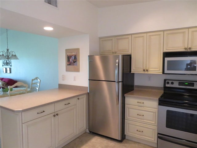 1360 Rio De Janeiro Ave Unit 117, Punta Gorda, FL 33983 - kitchen featuring stainless steel appliances, cream cabinetry, a chandelier, light countertops, and recessed lighting