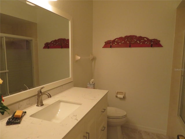 bathroom with tile patterned floors, vanity, toilet, and an enclosed shower