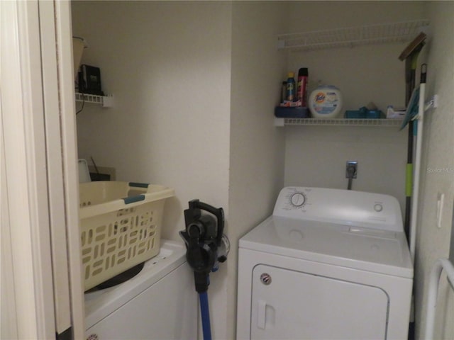 laundry room with washing machine and clothes dryer