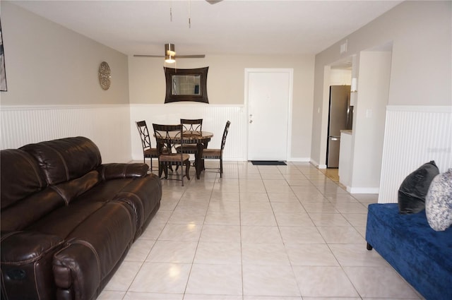 tiled living room with ceiling fan