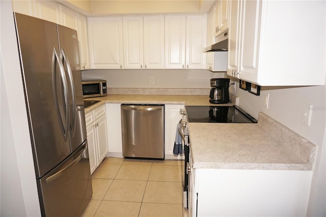 kitchen with white cabinets, light tile patterned floors, and appliances with stainless steel finishes