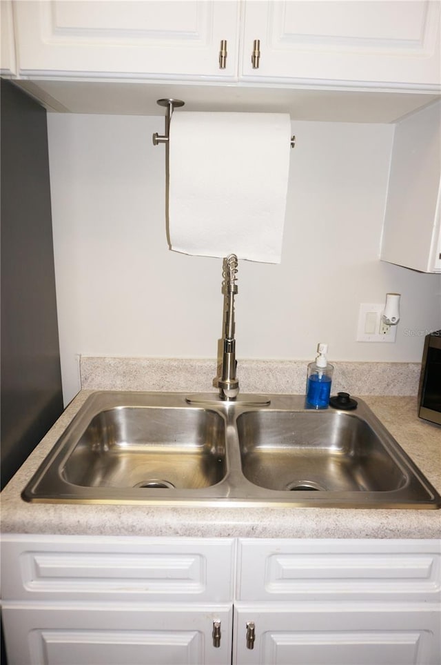 interior details with sink and white cabinets