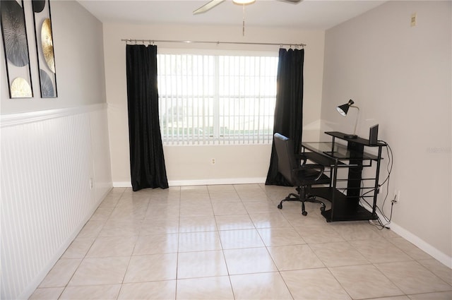 tiled home office featuring ceiling fan