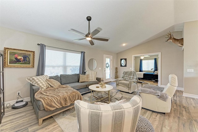 living room featuring light hardwood / wood-style floors, ceiling fan, and lofted ceiling