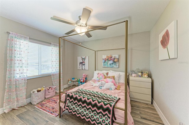 bedroom with ceiling fan and hardwood / wood-style floors