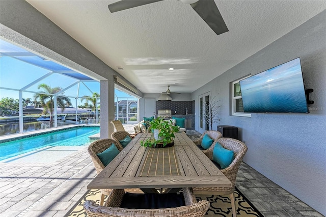 view of swimming pool with french doors, glass enclosure, ceiling fan, and a patio area