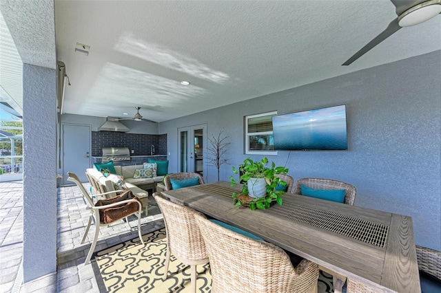 view of patio featuring area for grilling, ceiling fan, sink, and exterior kitchen