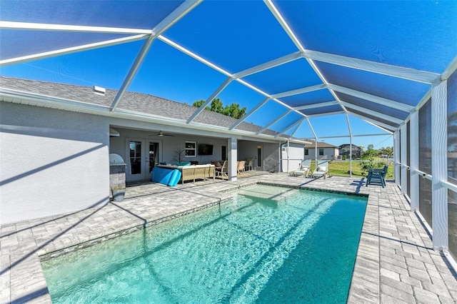 view of pool with a lanai, ceiling fan, a patio, and an outdoor hangout area