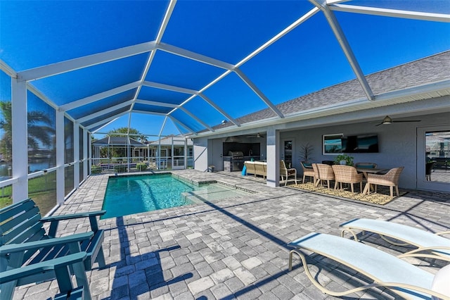 view of swimming pool featuring a lanai, ceiling fan, and a patio area