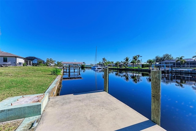 dock area featuring a yard and a water view