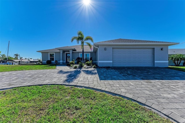 ranch-style house featuring a front lawn and a garage