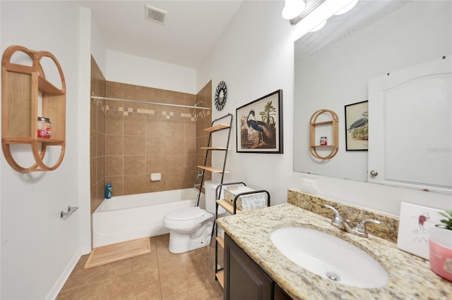 full bathroom featuring tile patterned flooring, tiled shower / bath, vanity, and toilet