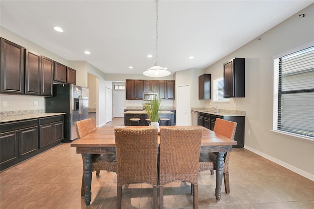 tiled dining space featuring sink