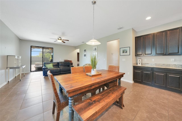 dining space with ceiling fan and light tile patterned floors