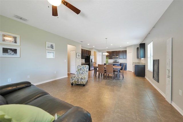 living room with light tile patterned floors and ceiling fan