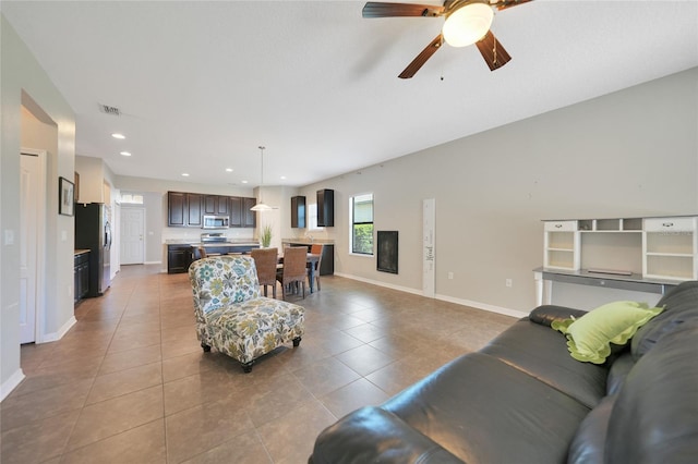 tiled living room featuring ceiling fan