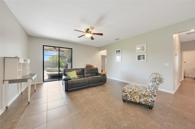 living room with ceiling fan and light tile patterned flooring