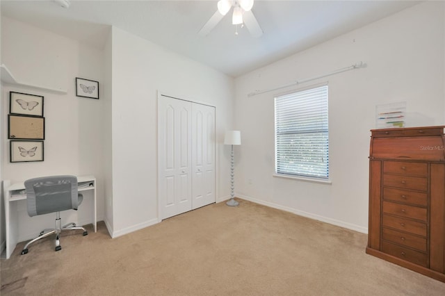 carpeted home office with ceiling fan