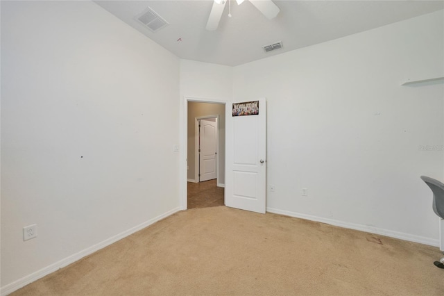 empty room with light colored carpet and ceiling fan