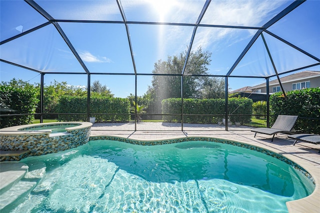 view of swimming pool featuring a lanai, a patio, and an in ground hot tub