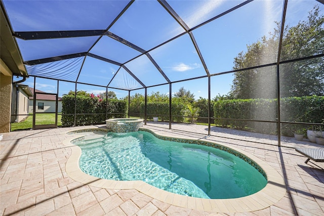 view of pool with an in ground hot tub, a patio, and glass enclosure