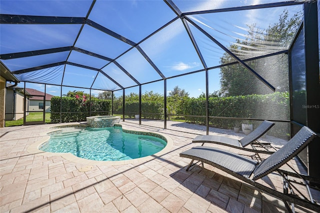 view of pool with an in ground hot tub, glass enclosure, and a patio