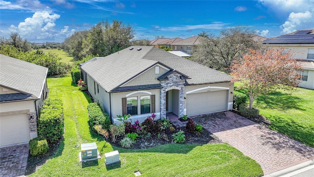 view of front of property featuring a garage and a front yard