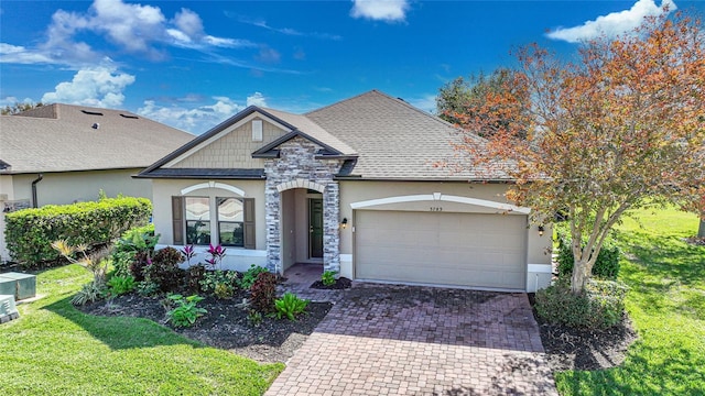 view of front of home with a garage and a front lawn