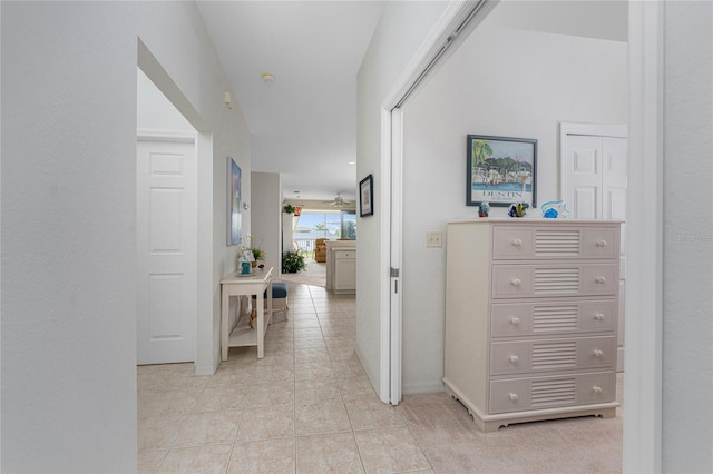 corridor featuring light tile patterned floors