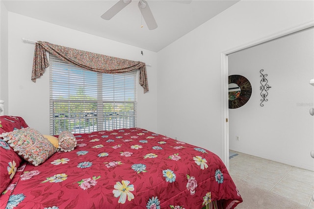 tiled bedroom featuring ceiling fan