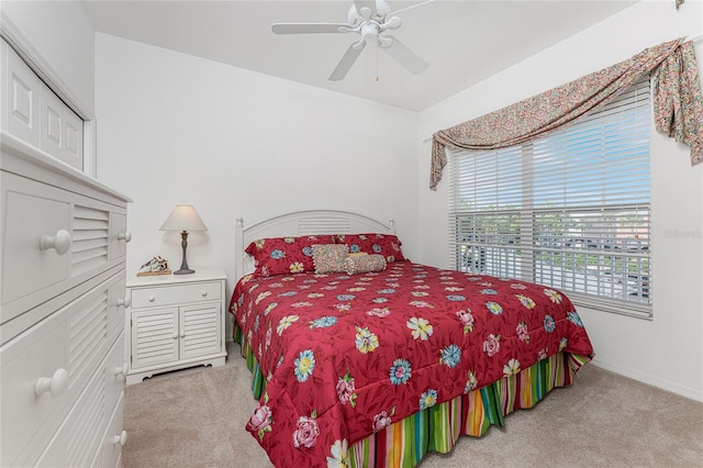 carpeted bedroom with ceiling fan and a closet