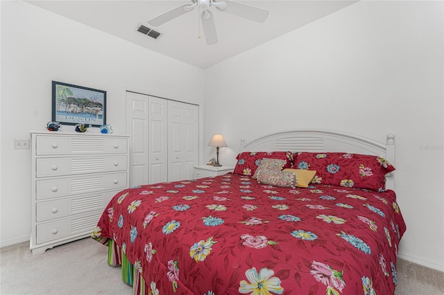 carpeted bedroom with ceiling fan and a closet