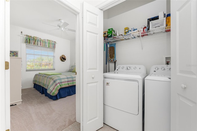 laundry room with ceiling fan, light carpet, and washing machine and clothes dryer