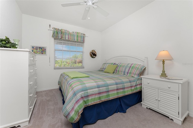 bedroom featuring ceiling fan, light colored carpet, and lofted ceiling