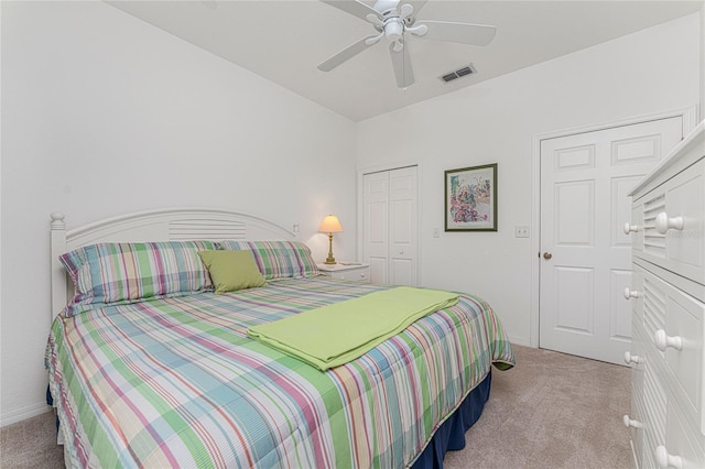 bedroom featuring a closet, ceiling fan, and light colored carpet