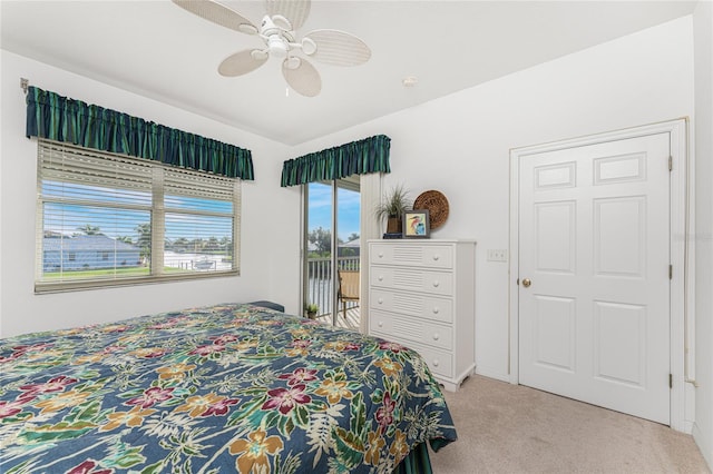 bedroom with ceiling fan, access to exterior, and light carpet