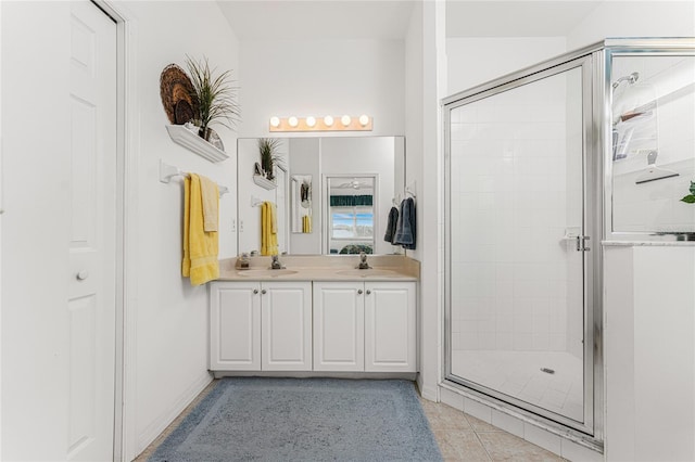 bathroom with tile patterned flooring, vanity, and a shower with door