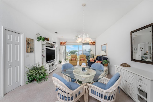 carpeted dining area with ceiling fan with notable chandelier