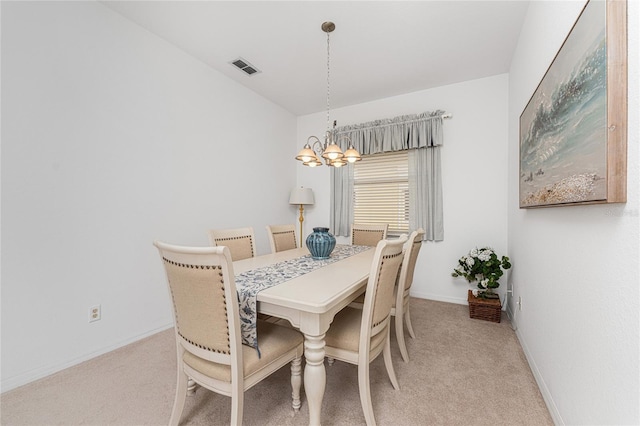 carpeted dining space with a notable chandelier