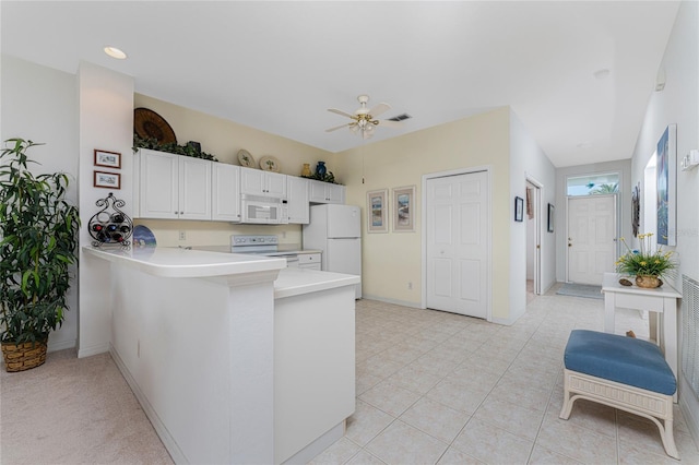 kitchen with white cabinetry, ceiling fan, kitchen peninsula, white appliances, and light tile patterned floors