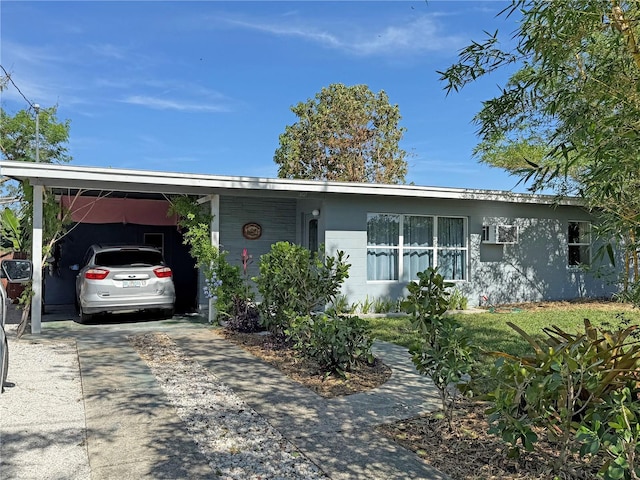 107 Dunn Dr NE, Port Charlotte, FL 33952 - ranch-style house with concrete driveway and an attached carport