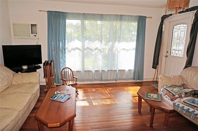 living room with a wall mounted AC and hardwood / wood-style floors