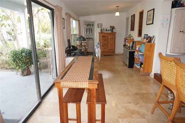 doorway to outside featuring lofted ceiling