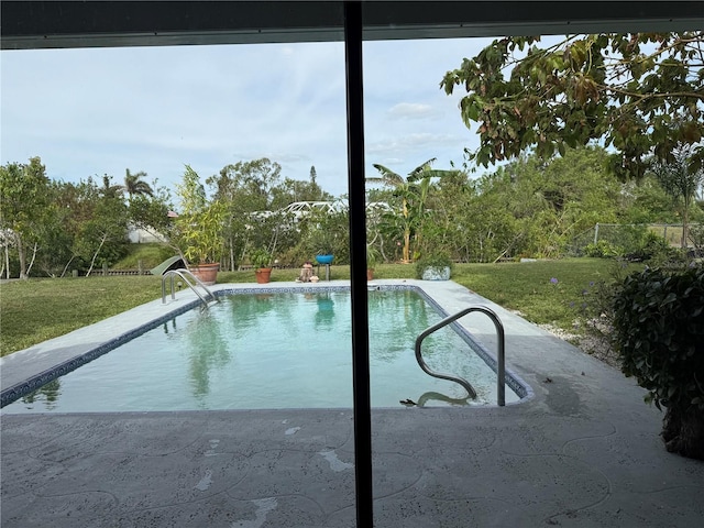 view of pool featuring a lawn