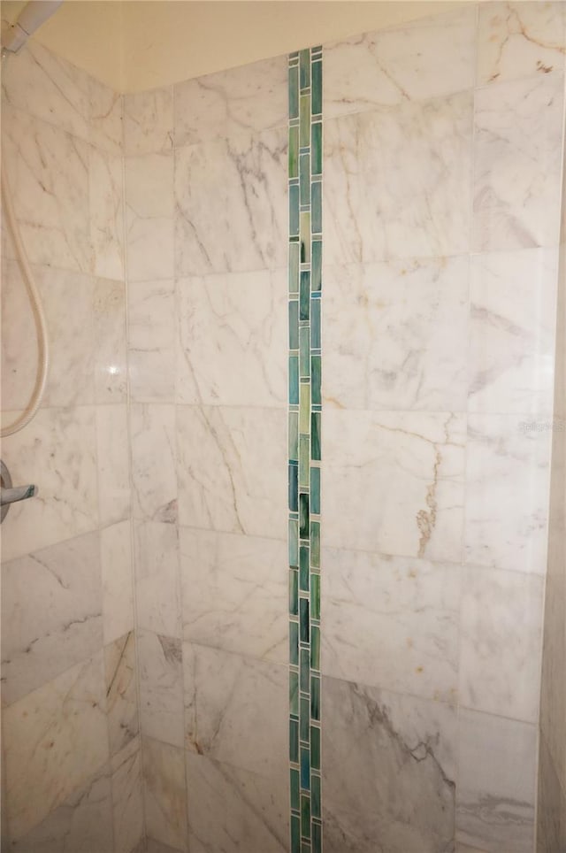 bathroom with a tile shower