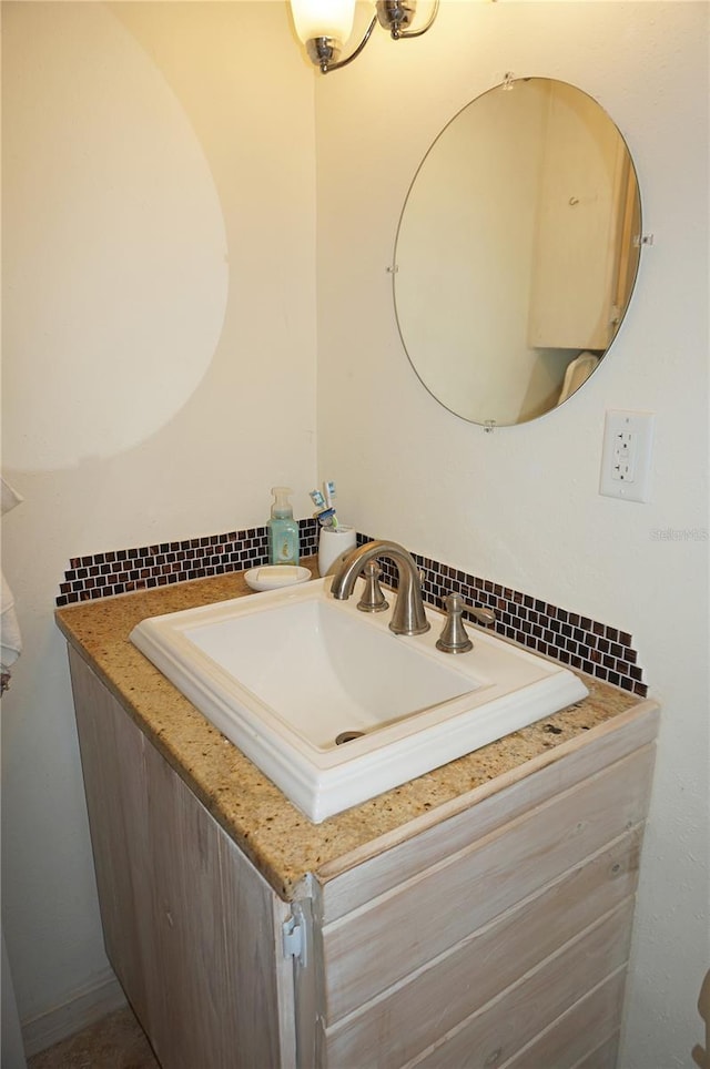 bathroom with vanity and tasteful backsplash