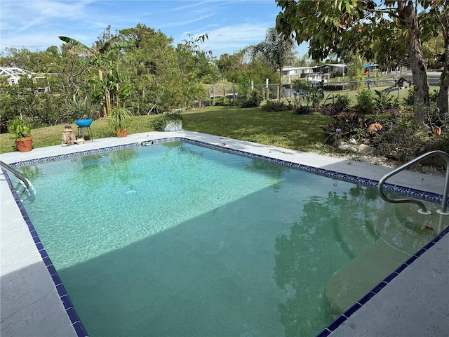 view of pool featuring a lawn